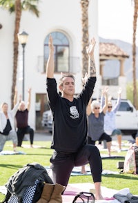 a group of people doing yoga in front of a building