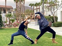 two people doing yoga in front of a house in palm springs