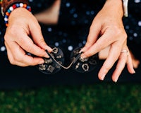 a woman's hands holding a pair of sunglasses