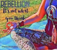 a woman sitting on the ground with the words rebellion it's not what you think